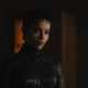 Selina standing in a dark room.